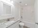 Bathroom with granite vanity, shower over tub and tiled walls at 23810 Sw Indian Hill Dr, Dunnellon, FL 34431
