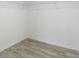 Walk-in closet featuring wire shelving and modern wood flooring at 23810 Sw Indian Hill Dr, Dunnellon, FL 34431