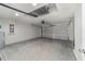 Garage with a garage door, concrete floor, electrical panel and water heater at 23810 Sw Indian Hill Dr, Dunnellon, FL 34431
