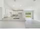 Bright kitchen with white cabinetry, granite countertops, and stainless sink at 23810 Sw Indian Hill Dr, Dunnellon, FL 34431