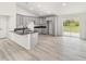 Open kitchen with gray cabinets, black countertops, and wood-look flooring at 23810 Sw Indian Hill Dr, Dunnellon, FL 34431