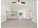 Bright living space with gray floors, white walls, and modern ceiling fan at 23810 Sw Indian Hill Dr, Dunnellon, FL 34431