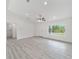 Bright living space with gray floors, white walls, and a large window at 23810 Sw Indian Hill Dr, Dunnellon, FL 34431