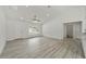 Bright living room with gray floors, white walls, and view to a bathroom at 23810 Sw Indian Hill Dr, Dunnellon, FL 34431