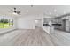 Bright open concept with kitchen, living room and dining room combo, wood-look floors and vaulted ceiling at 23810 Sw Indian Hill Dr, Dunnellon, FL 34431