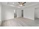 Large main bedroom with tray ceiling, ceiling fan, and bathroom and closet access at 23810 Sw Indian Hill Dr, Dunnellon, FL 34431