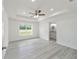 Spacious main bedroom with tray ceiling, ceiling fan, and en-suite bathroom access at 23810 Sw Indian Hill Dr, Dunnellon, FL 34431