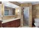 A traditional style bathroom with a large framed mirror and a tiled shower enclosure for a spa-like experience at 257 Donegal Ct, Altamonte Springs, FL 32714