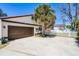 Spacious driveway and garage with manicured landscaping and a white picket fence at 257 Donegal Ct, Altamonte Springs, FL 32714
