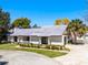 A charming one story home boasts a well-manicured front yard, complemented by a white picket fence at 257 Donegal Ct, Altamonte Springs, FL 32714