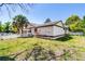 Exterior view of the home featuring a manicured lawn and mature palm trees at 257 Donegal Ct, Altamonte Springs, FL 32714