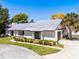 Beautiful single-story home with a well-kept lawn and charming white picket fence and mature landscaping at 257 Donegal Ct, Altamonte Springs, FL 32714