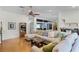 Bright living room features a ceiling fan, hardwood flooring and a large sectional sofa with decorative pillows at 257 Donegal Ct, Altamonte Springs, FL 32714