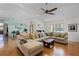 Bright living room features a ceiling fan, many windows and an oversized sectional sofa with decorative pillows at 257 Donegal Ct, Altamonte Springs, FL 32714