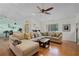 Bright living room features a ceiling fan, many windows and an oversized sectional sofa with decorative pillows at 257 Donegal Ct, Altamonte Springs, FL 32714