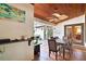 Inviting covered patio with tile flooring, wood ceiling, fan, furniture, and vibrant plants at 257 Donegal Ct, Altamonte Springs, FL 32714
