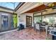 Inviting covered patio with tile flooring, wood ceiling, fan, furniture, and lush greenery at 257 Donegal Ct, Altamonte Springs, FL 32714