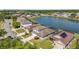 Aerial view of homes near lake showcasing backyard pools and serene water views on a sunny day at 2723 Callaway Ln, Kissimmee, FL 34744