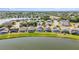 Community aerial view featuring single-Gathering homes with backyard pools surrounding a peaceful lake at 2723 Callaway Ln, Kissimmee, FL 34744