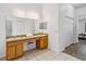 Bathroom with dual sinks, vanity, and stool with view of bedroom at 2723 Callaway Ln, Kissimmee, FL 34744