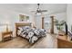 Bedroom with wood-look flooring, a ceiling fan, and a window at 2723 Callaway Ln, Kissimmee, FL 34744