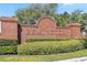 Community entrance sign for Remington with brick structure and lush greenery at 2723 Callaway Ln, Kissimmee, FL 34744