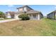 Charming two-story home featuring a two-car garage, a covered porch, and a well-maintained lawn at 2723 Callaway Ln, Kissimmee, FL 34744