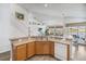 Bright kitchen with wooden cabinets, an island, and view of the living room and outdoor area with a pool at 2723 Callaway Ln, Kissimmee, FL 34744