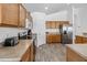 Kitchen featuring wood cabinets, stainless steel appliances, and ample counter space, with a door to another room at 2723 Callaway Ln, Kissimmee, FL 34744
