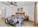 Comfortable main bedroom with ceiling fan, wood-look floors, and decor at 2723 Callaway Ln, Kissimmee, FL 34744