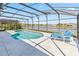 Screened pool with lake view and lounge chairs at 2723 Callaway Ln, Kissimmee, FL 34744