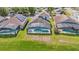 Aerial view of backyards with screened-in pools on a sunny day, showcasing outdoor living at 2723 Callaway Ln, Kissimmee, FL 34744
