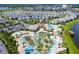 An aerial view of a community pool area with lazy river and a mini golf course at 2964 Protagonist St, Kissimmee, FL 34746