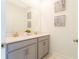 Modern bathroom with dual sinks, light gray cabinets, and a large mirror at 2964 Protagonist St, Kissimmee, FL 34746