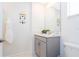 A half bathroom features gray cabinets, a white countertop, and an accent wall hanging at 2964 Protagonist St, Kissimmee, FL 34746