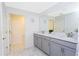 Bright bathroom with double sinks, gray cabinets, and ample countertop space provides a modern and functional design at 2964 Protagonist St, Kissimmee, FL 34746