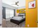 Modern bedroom with accent wall, ceiling fan and carpet flooring at 2964 Protagonist St, Kissimmee, FL 34746