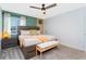 Well-lit bedroom features a king bed, modern furnishings, and a stylish accent wall, creating a serene retreat at 2964 Protagonist St, Kissimmee, FL 34746