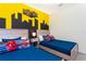 Bright bedroom with two twin beds, superhero decor, and colorful accents at 2964 Protagonist St, Kissimmee, FL 34746