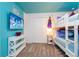 A themed bedroom features a flat-screen TV, a white dresser, and playful decor at 2964 Protagonist St, Kissimmee, FL 34746