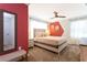 This bedroom has a ceiling fan, neutral walls, and warm-colored decor at 2964 Protagonist St, Kissimmee, FL 34746