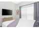 Well-lit bedroom features a TV, side table and curtains creating an inviting atmosphere at 2964 Protagonist St, Kissimmee, FL 34746