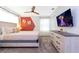 Cozy bedroom featuring stylish furniture, a flat-screen TV, and warm natural light at 2964 Protagonist St, Kissimmee, FL 34746