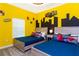 A kid-friendly bedroom featuring dual beds with superhero decor and vibrant yellow walls at 2964 Protagonist St, Kissimmee, FL 34746