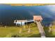 An aerial view of the boat dock with kayaks and a gazebo over the lake at 2964 Protagonist St, Kissimmee, FL 34746