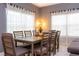 Inviting dining area with modern table and chairs, bathed in natural light from large windows at 2964 Protagonist St, Kissimmee, FL 34746