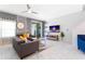 Contemporary living room featuring a comfortable sectional sofa, stylish decor and a sliding glass door to the patio at 2964 Protagonist St, Kissimmee, FL 34746