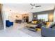 Open-concept living area with sleek tile flooring, modern furnishings, and a view of the kitchen at 2964 Protagonist St, Kissimmee, FL 34746