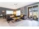 Well-lit living area with neutral decor opens to a dining area and screened-in patio with comfortable seating at 2964 Protagonist St, Kissimmee, FL 34746
