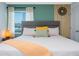Cozy main bedroom featuring a decorative headboard, stylish accents, and natural light at 2964 Protagonist St, Kissimmee, FL 34746